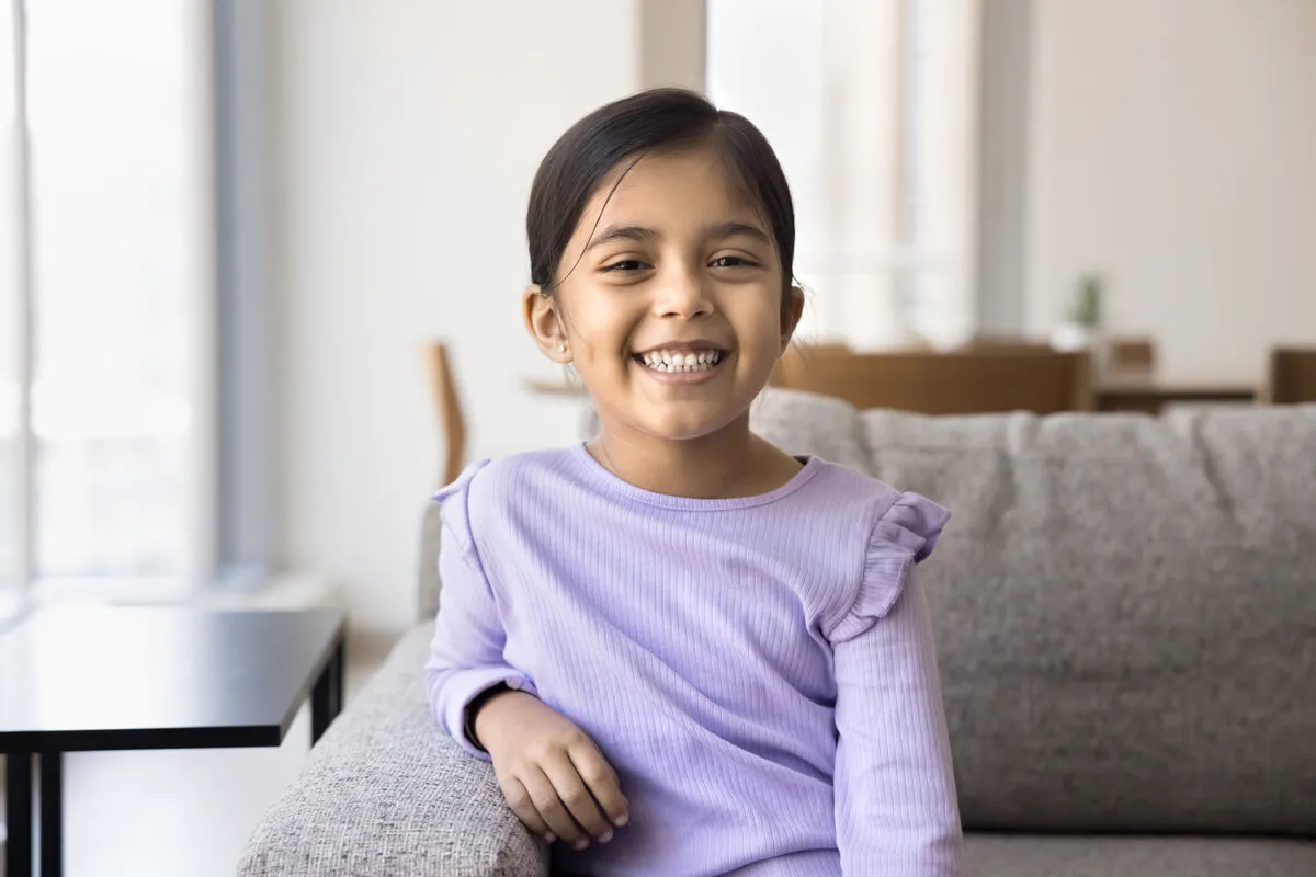 Girl smiling on a couch